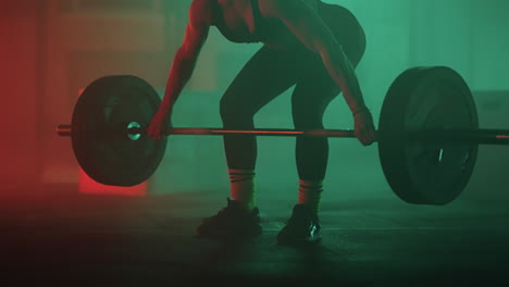 athletic-woman-is-lifting-barbell-with-weights-in-gym-training-her-endurance-and-strength